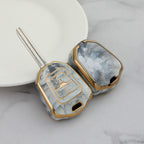 Isuzu Autoschlüsseletui, goldfarben mit Jade-Einlage